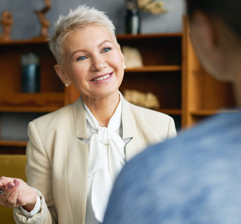 Portrait of experienced stylish human resources woman manager conducting job interview with young female applicant, asking her to tell about work experience, personal qualities and professional skills